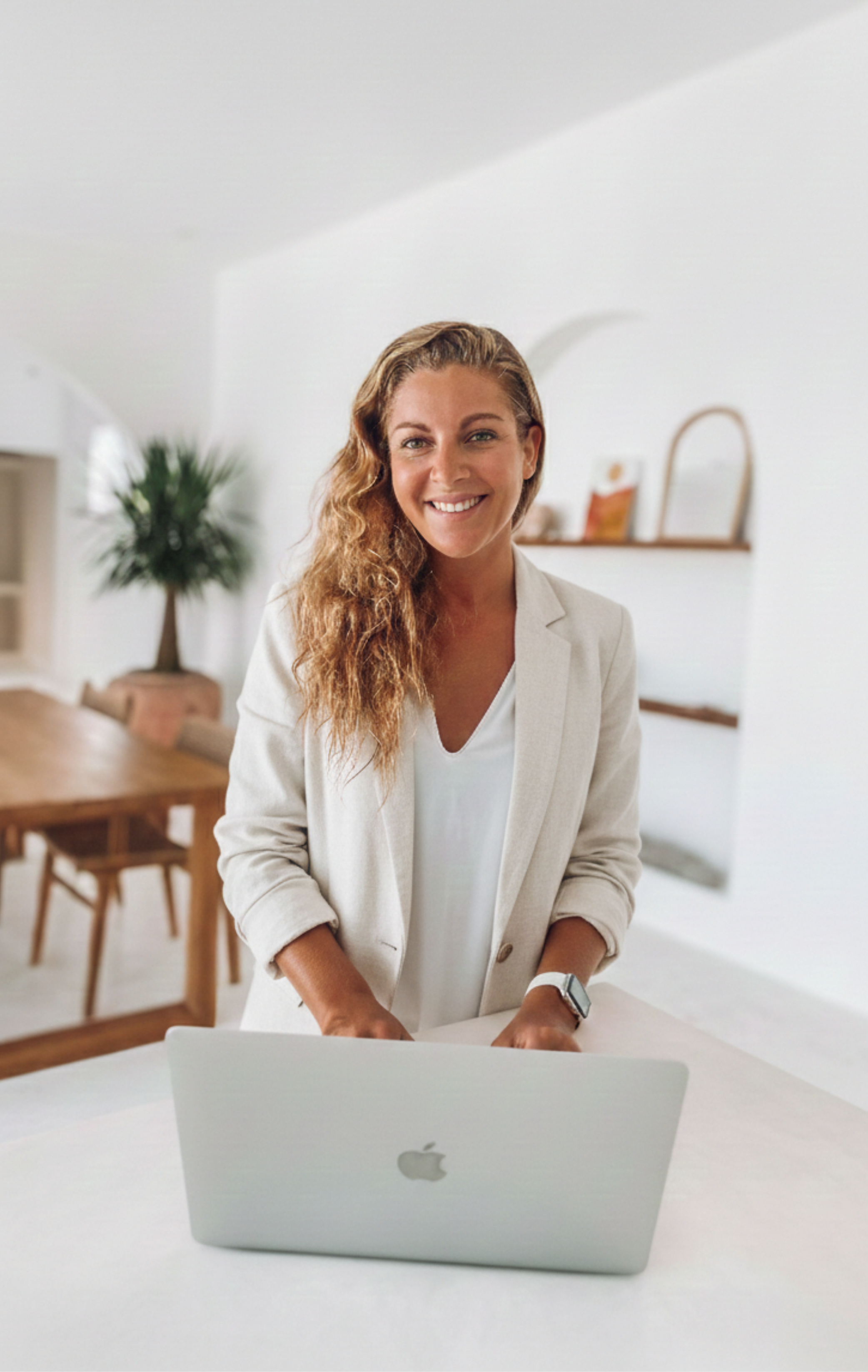 Verena Husemann working at her desk in a bright Mediterranean interior
